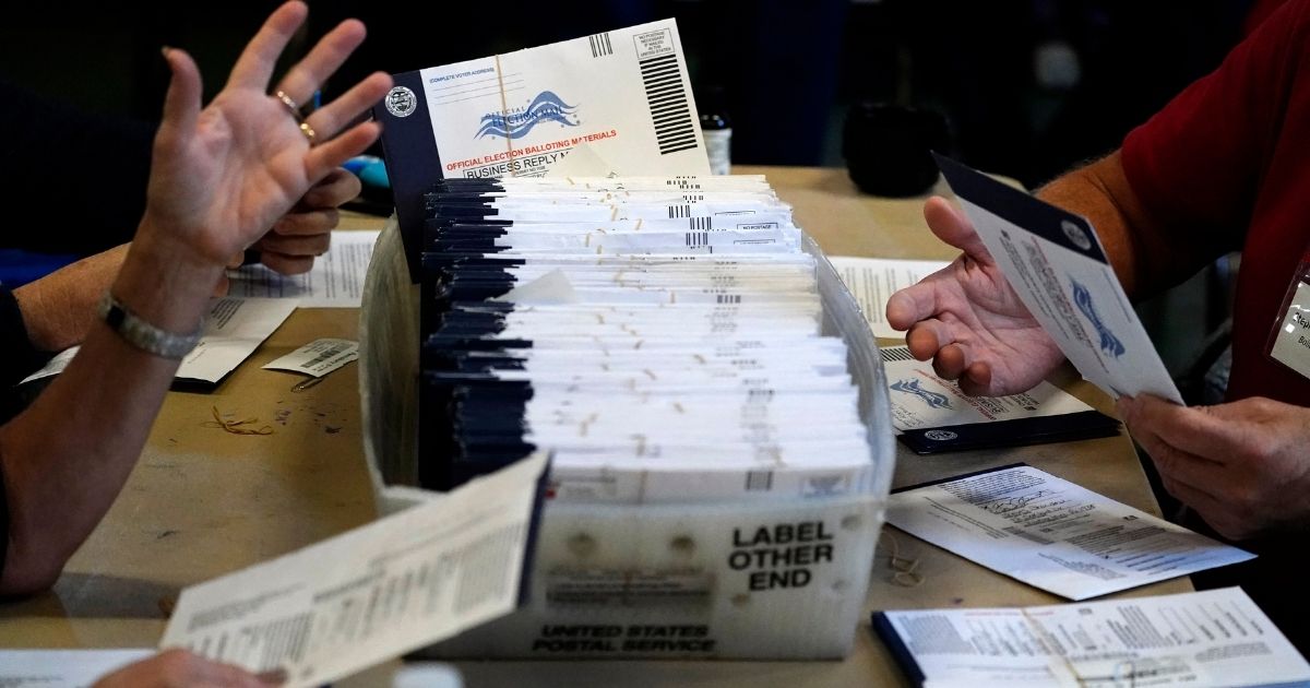 Chester County election workers process mail-in and absentee ballots for the 2020 general election in the United States at West Chester University on Nov. 4, 2020, in West Chester, Pennsylvania.