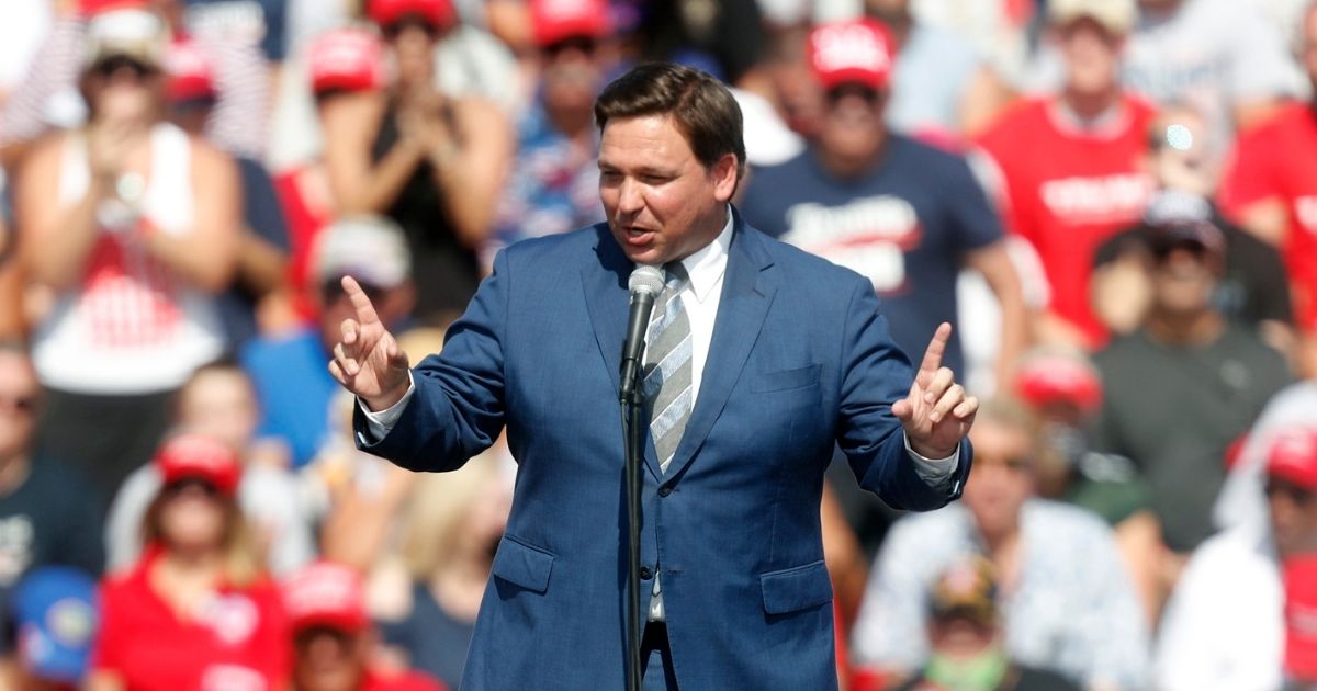 Florida Gov. Ron DeSantis speaks to supporters of President Donald Trump before he arrives to give a campaign speech just four days before Election Day outside of Raymond James Stadium on Oct. 29, 2020, in Tampa, Florida.