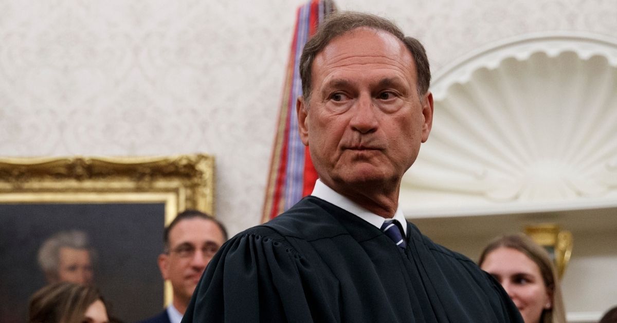 Supreme Court Justice Samuel Alito pauses after swearing in Mark Esper as secretary of defense during a ceremony with President Donald Trump in the Oval Office at the White House in Washington on July 23, 2019.