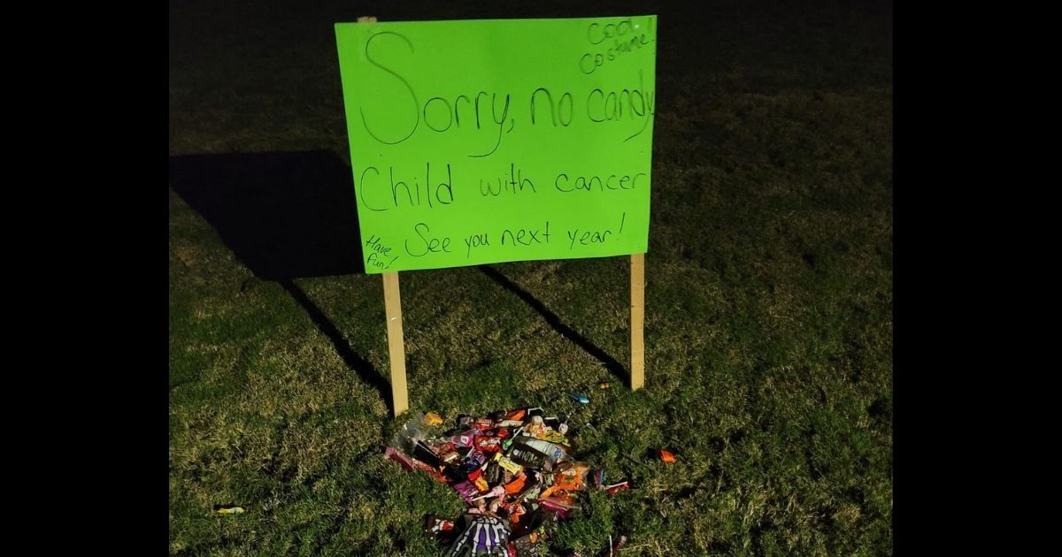 The sign in Courtney Thomas' front yard, where trick-or-treaters left candy offerings on Halloween night.