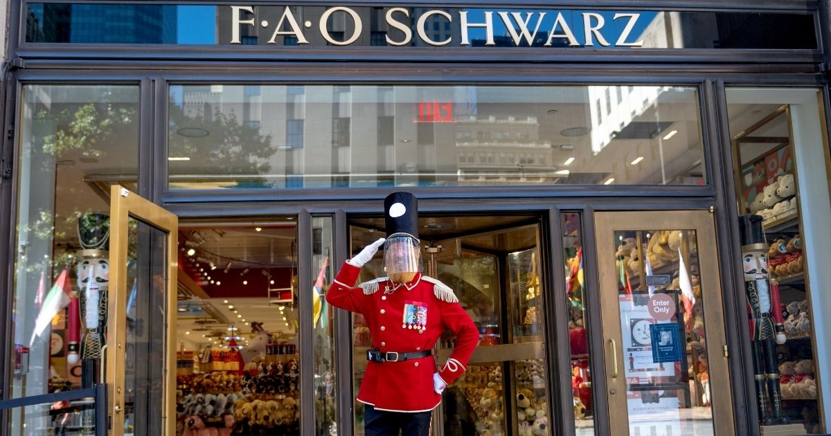 A person dressed as a nutcracker wearing a face shields stands at the entrance to FAO Schwarz in Rockefeller Center on Oct.17 in New York City.