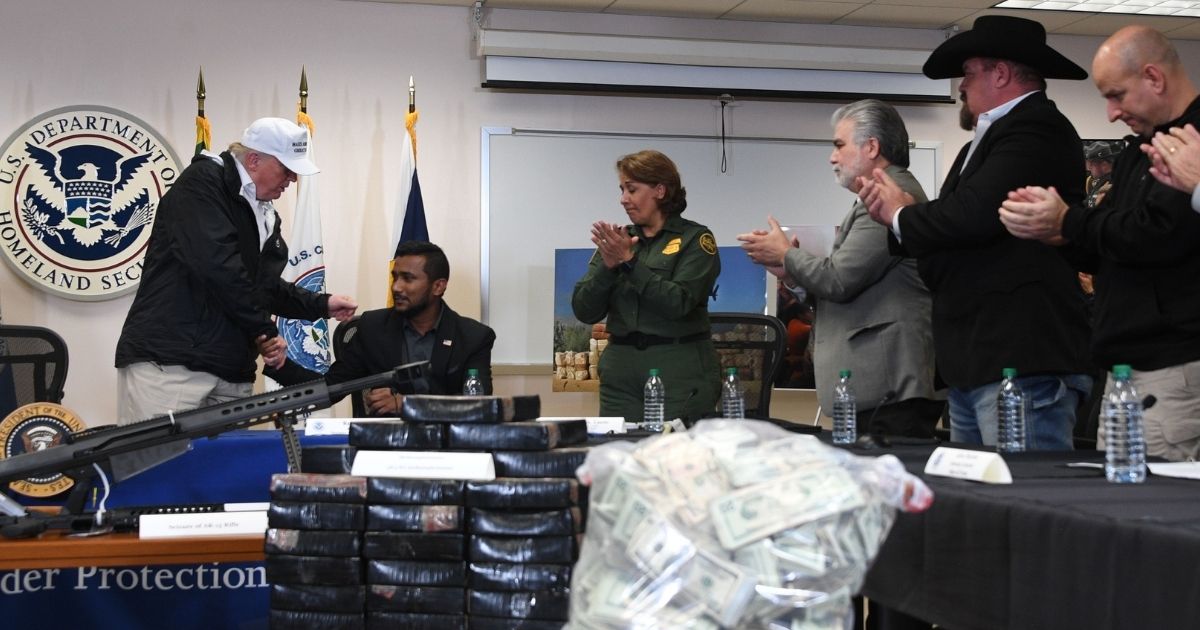 President Donald Trump speaks with Reggie Singh, the brother of Ronil Singh, a Newman, California, police corporal killed by an illegal immigrant, during his visit to the U.S. Border Patrol station in McAllen, Texas, on Jan. 10, 2019.