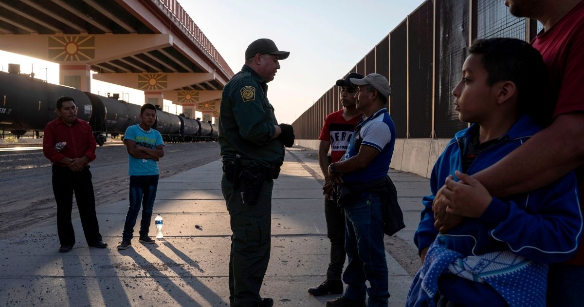 U.S. Customs and Border Protection agent questions a migrant about a boy he is traveling with May 16, 2019, in El Paso, Texas.