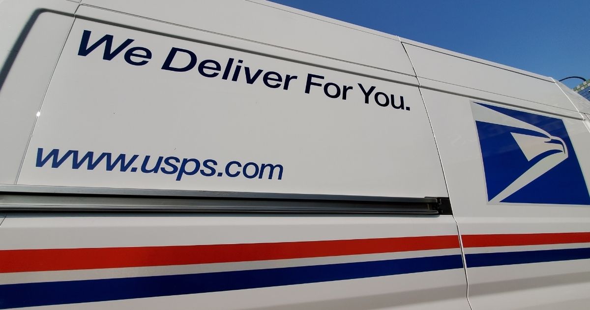The United States Postal Service slogan is seen on a USPS truck in Lafayette, California, on Sept. 17.