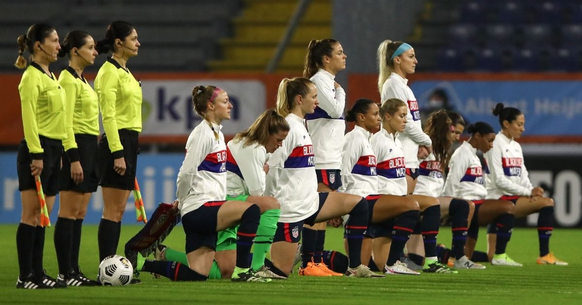 Members of the U.S. Women's National Team kneel during the national anthem before a friendly match against the Netherlands at Rat Verlegh Stadium in Breda on Friday.