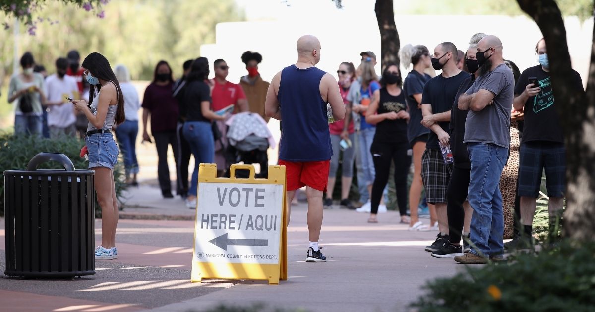 Voters wait in line at the courthouse Tuesday in Surprise, Arizona.