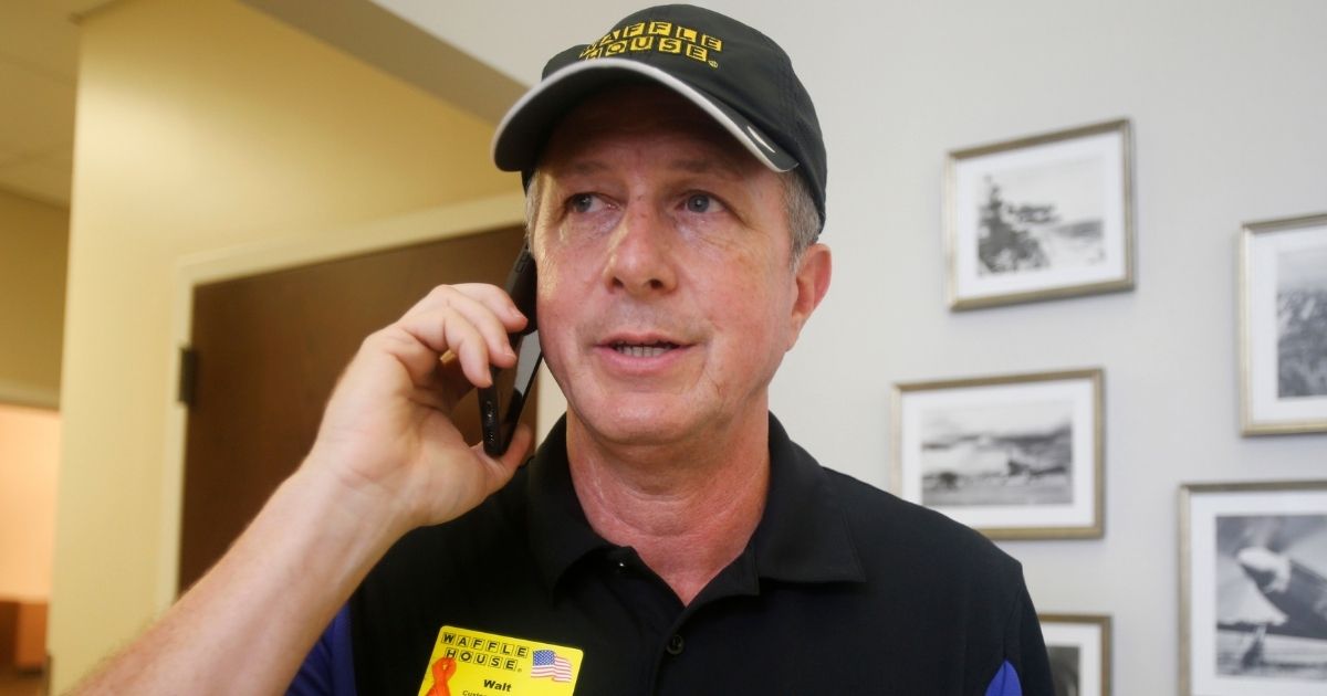 Walt Ehmer, president and CEO of the Waffle House restaurant chain, speaks on the phone after landing in Wilmington, North Carolina, with an emergency response team shortly after Hurricane Florence struck the Tar Heel State in September 2018.