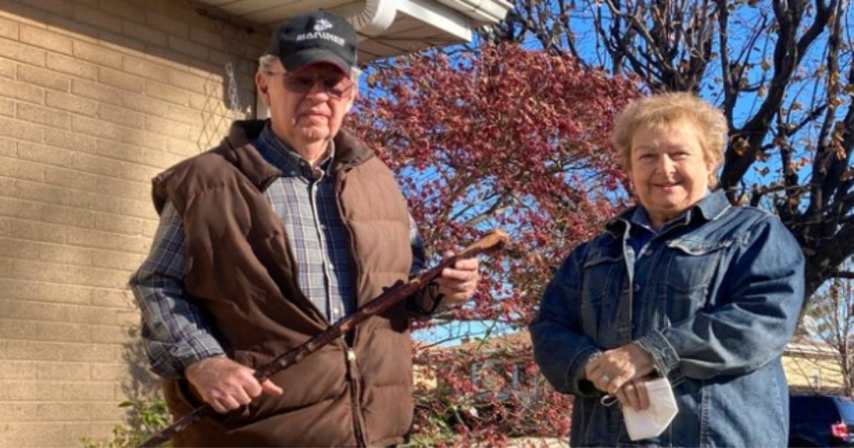 With his wife by his side, ex-Marine Dan Donovan holds the antique shillelagh he used to chase three intruders from his suburban Chicago home on Nov. 4, 2020.