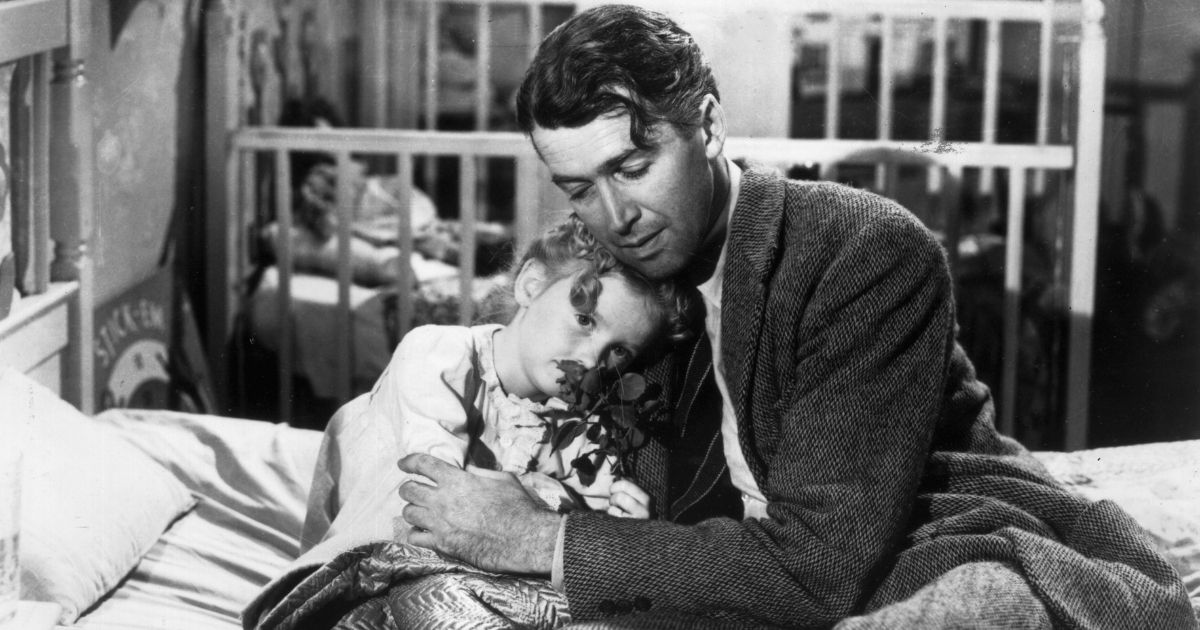 Actor Jimmy Stewart, portraying George Bailey, hugs actor Karolyn Grimes (portraying Zuzu, his daughter) in a still photo from the 1946 classic Christmas film 'It's a Wonderful Life.'