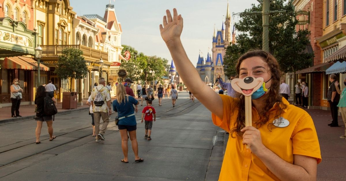 In this handout photo from the Walt Disney World Resort, a Disney cast member welcomes guests to the Magic Kingdom in Lake Buena Vista, Florida, on July 11, 2020, the first day of the park's phased reopening.