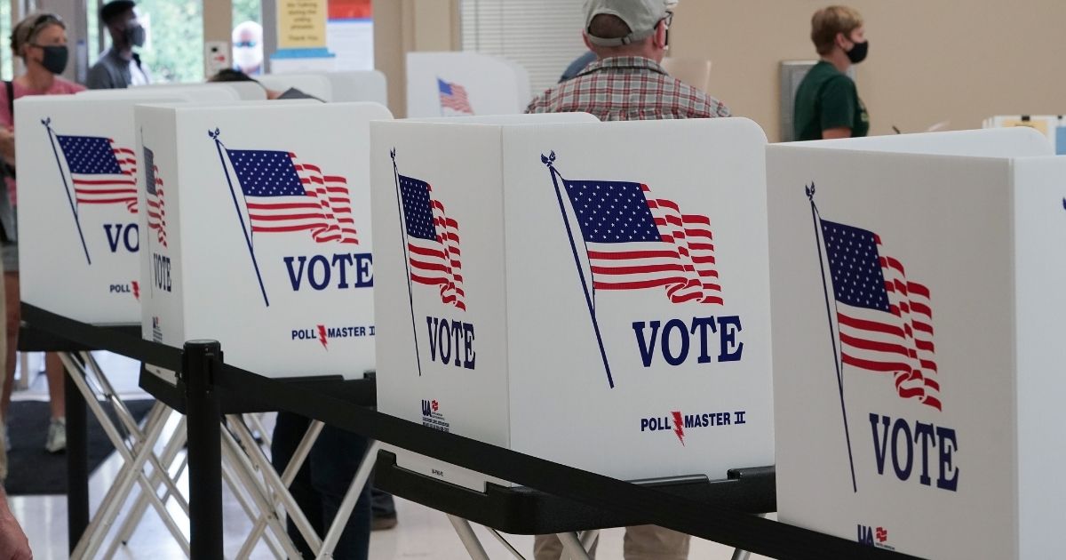 Voting booths stand ready to receive voters lined up to vote on the second day of early voting at the Hamilton County Election Commission on Oct. 15, 2020, in Chattanooga, Tennessee.