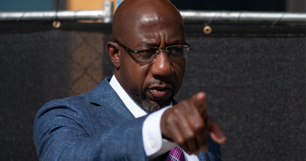 Democratic U.S. Senate candidate Raphael Warnock gestures after casting his ballot at the State Farm Arena in Atlanta on Oct. 21.
