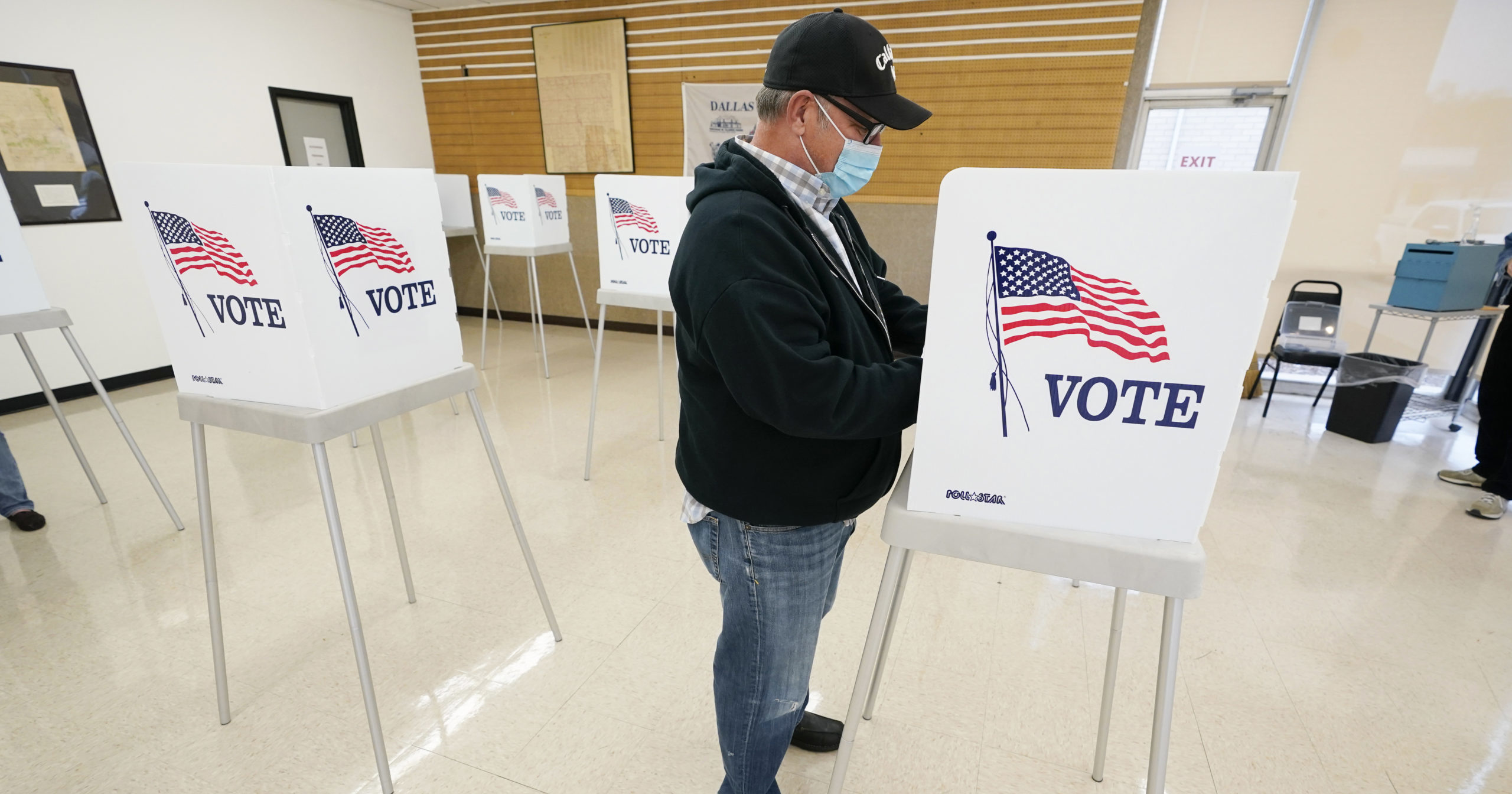 In this Oct. 20, 2020 file photo, Kelly Wingfield, of Urbandale, Iowa, fills out his ballot during early voting in the general election, in Adel, Iowa.
