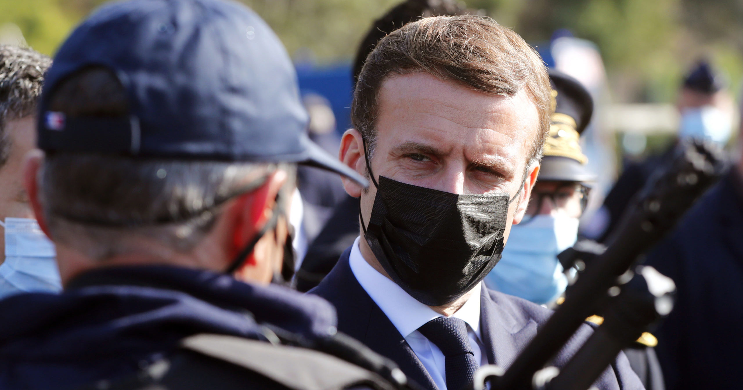 French President Emmanuel Macron speaks with a police officer during a visit to the border between Spain and France at Le Perthus, France, on Nov. 5, 2020.