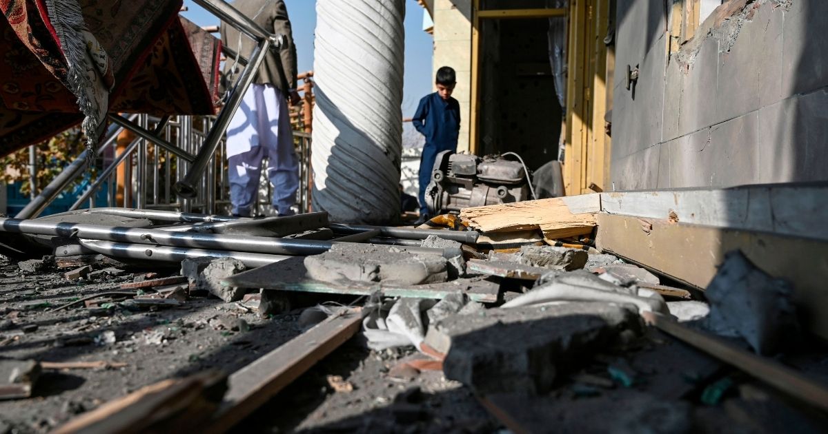 People inspect a damaged house after several rockets landed in Kabul, Afghanistan, on Nov. 21, 2020.