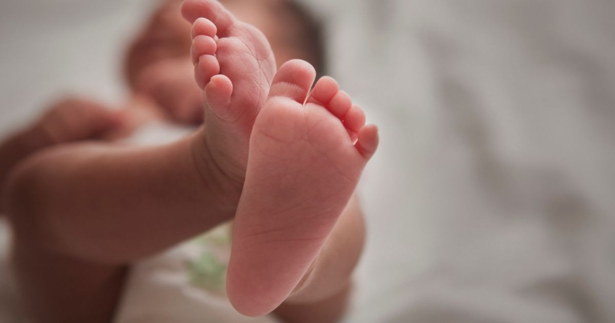 A newborn baby is seen in the above stock image.