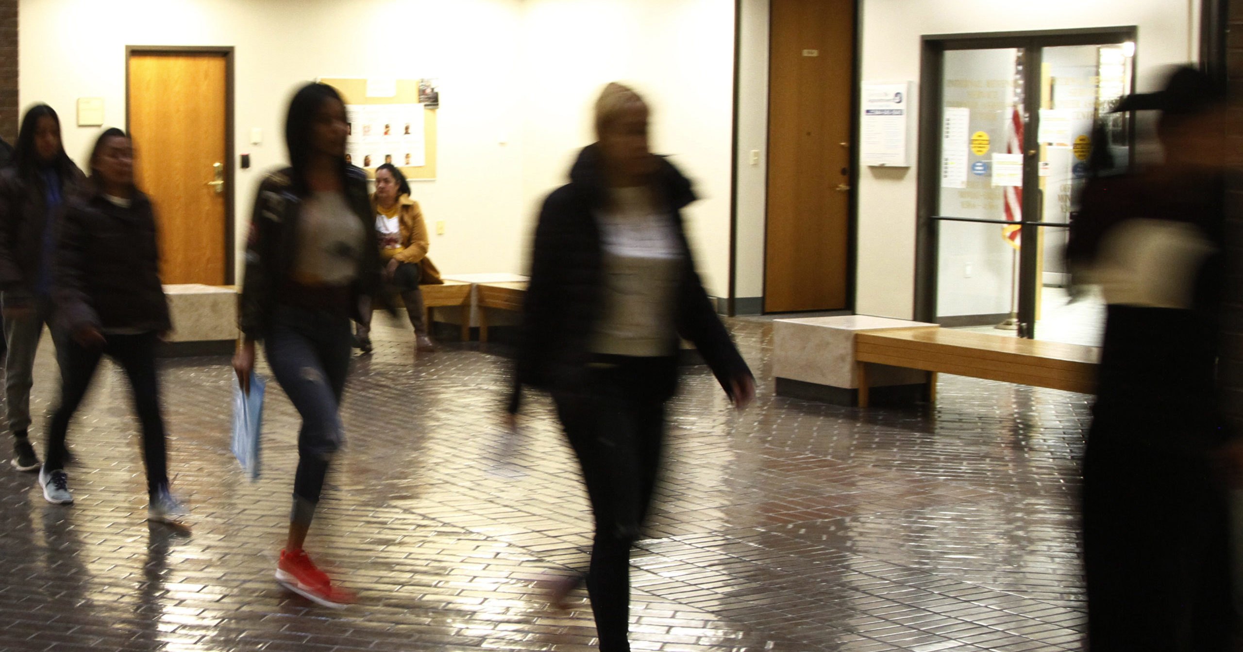 In this Nov. 19, 2019, file photo, asylum seekers from Central America and Cuba follow an Immigration and Customs Enforcement guard into the Richard C. White Federal Building in El Paso, Texas.