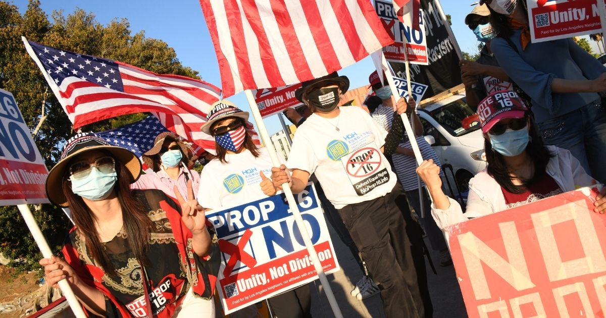 Protesters wave American flags as they demonstrate against Prop. 16 on Oct. 30, 2020, in Los Angeles, California.