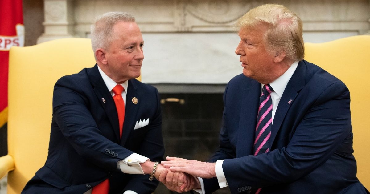 Rep. Jeff Van Drew of New Jersey shakes hands with President Donald Trump in the Oval Office of the White House on Dec. 19, 2019, in Washington, D.C.