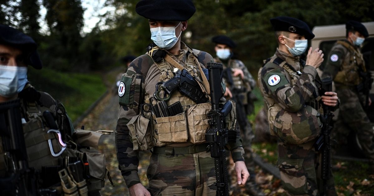 French soldiers of the Sentinelle force get ready before setting off on a patrol at an undisclosed location in northern suburban Paris on Nov. 6, 2020. The Sentinelle force protects sensitive points of France from terrorism.