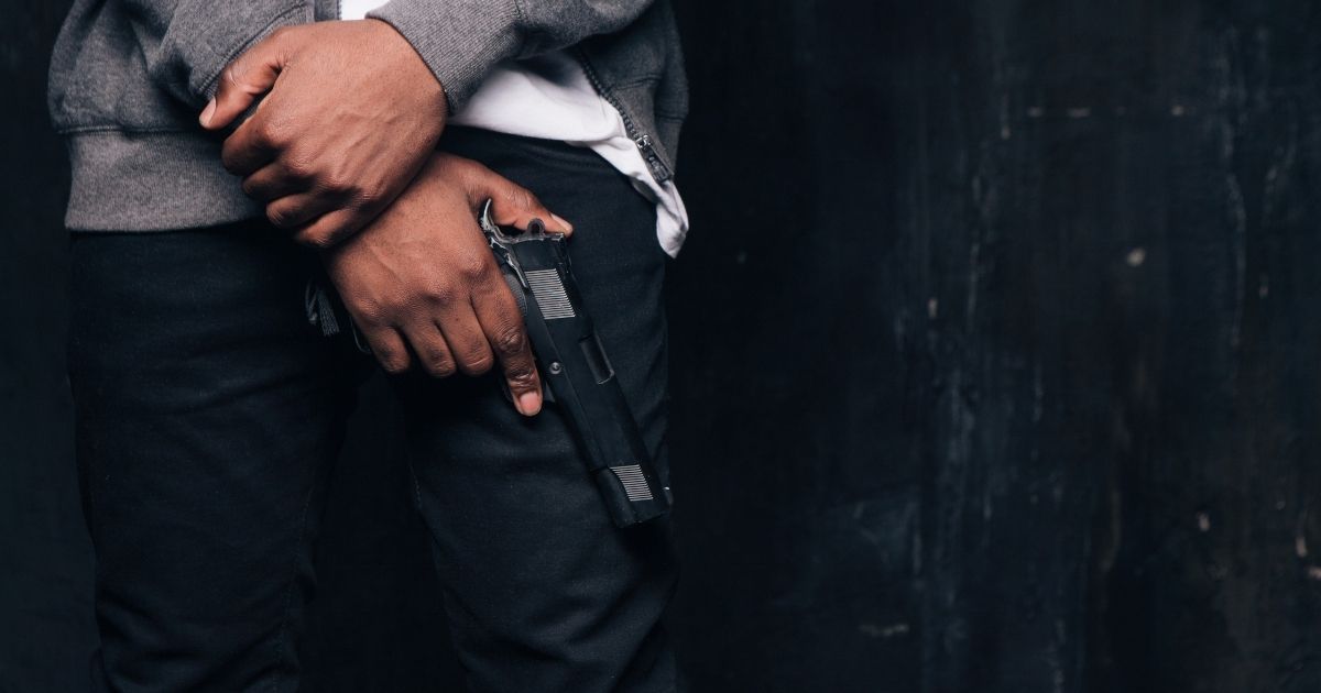 A man holds a gun in this stock image.