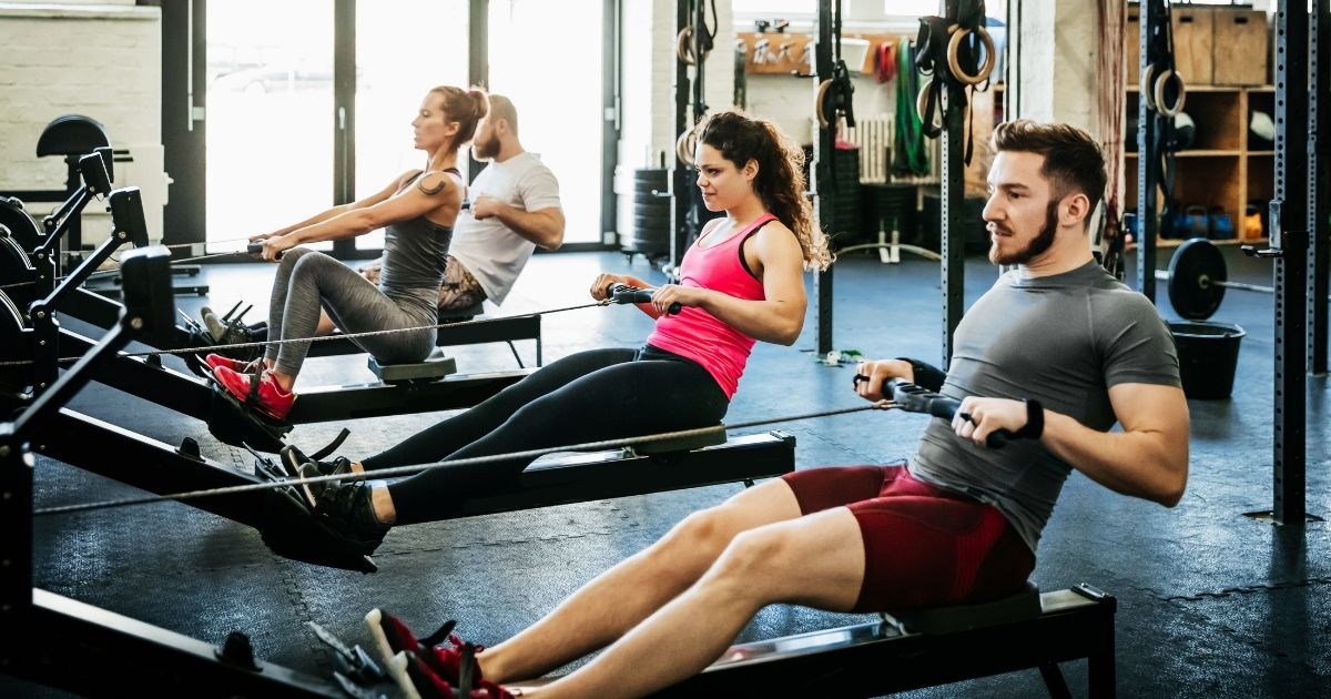 People work out in a gym in this stock image.