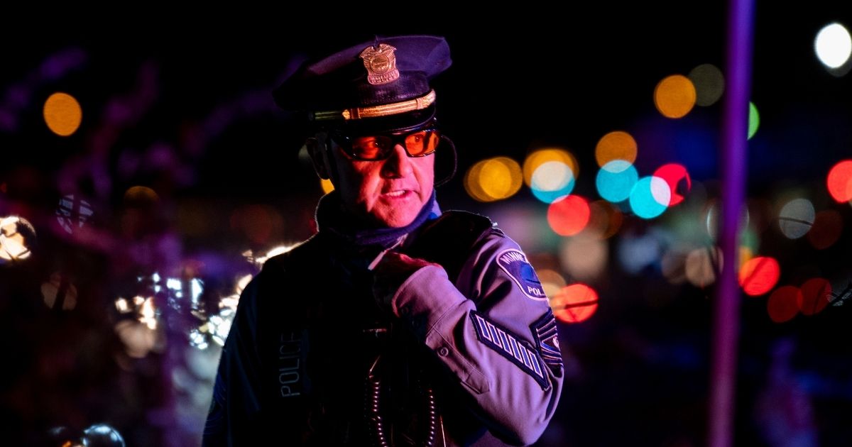 A member of the Minneapolis Police Department speaks into his radio as demonstrators march on highway I-94 on Nov. 4, 2020, in Minneapolis, Minnesota.