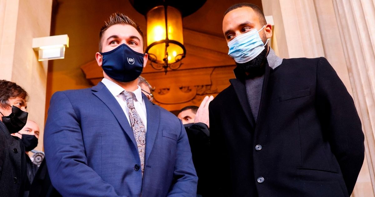 Anthony Sadler, right, and Alek Skarlatos stand outside a courthouse in Paris on Nov. 20, 2020, on the second day of the trial of Ayoub El Khazzani, a Moroccan man whose attempted terror attack on an Amsterdam-Paris train in 2015 was foiled by passengers including Sadler, Skarlatos and their friend Spencer Stone.