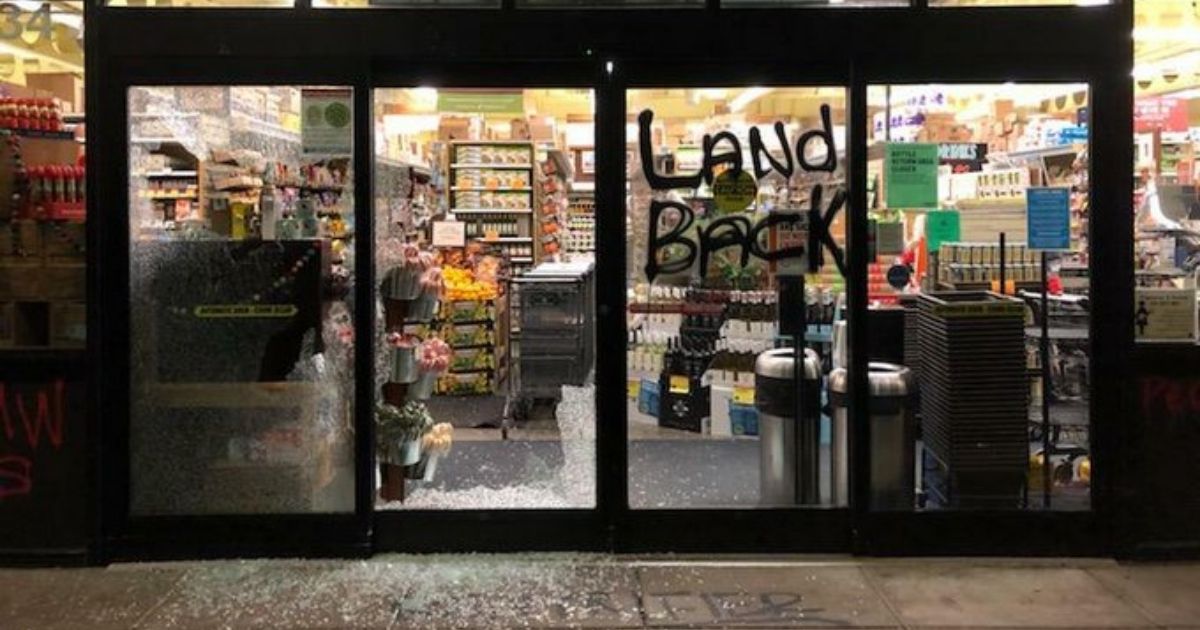 A group of rioters in Portland broke multiple windows and defaced storefronts during Thanksgiving Day unrest on Nov. 26, 2020.