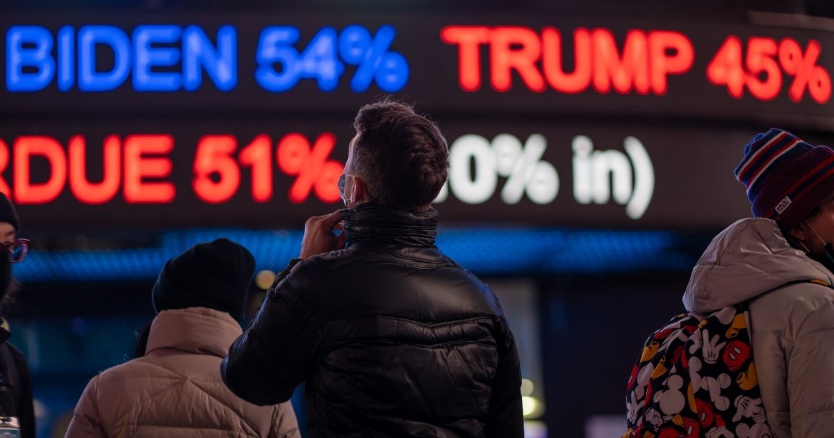 People gather in Times Square in New York City as they await election results on Tuesday.
