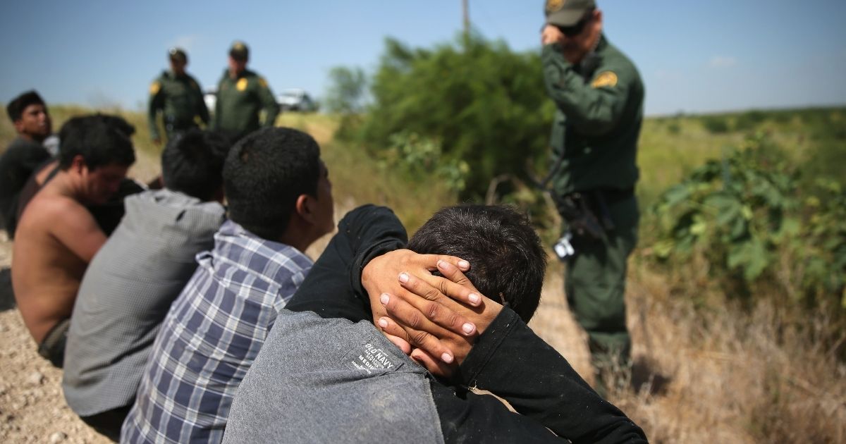 Border Patrol agents detain illegal immigrants after they crossed the border from Mexico into the United States on Aug. 7, 2015, in McAllen, Texas.