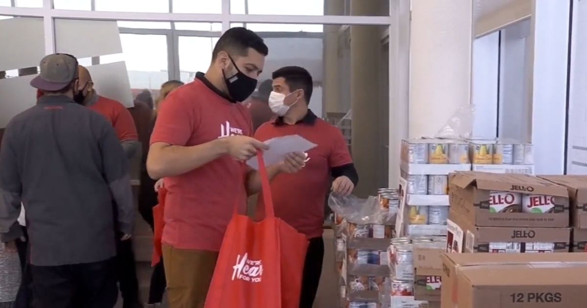 Volunteers help pack meal kits for veterans that were given out on Tuesday in Salt Lake City, Utah.