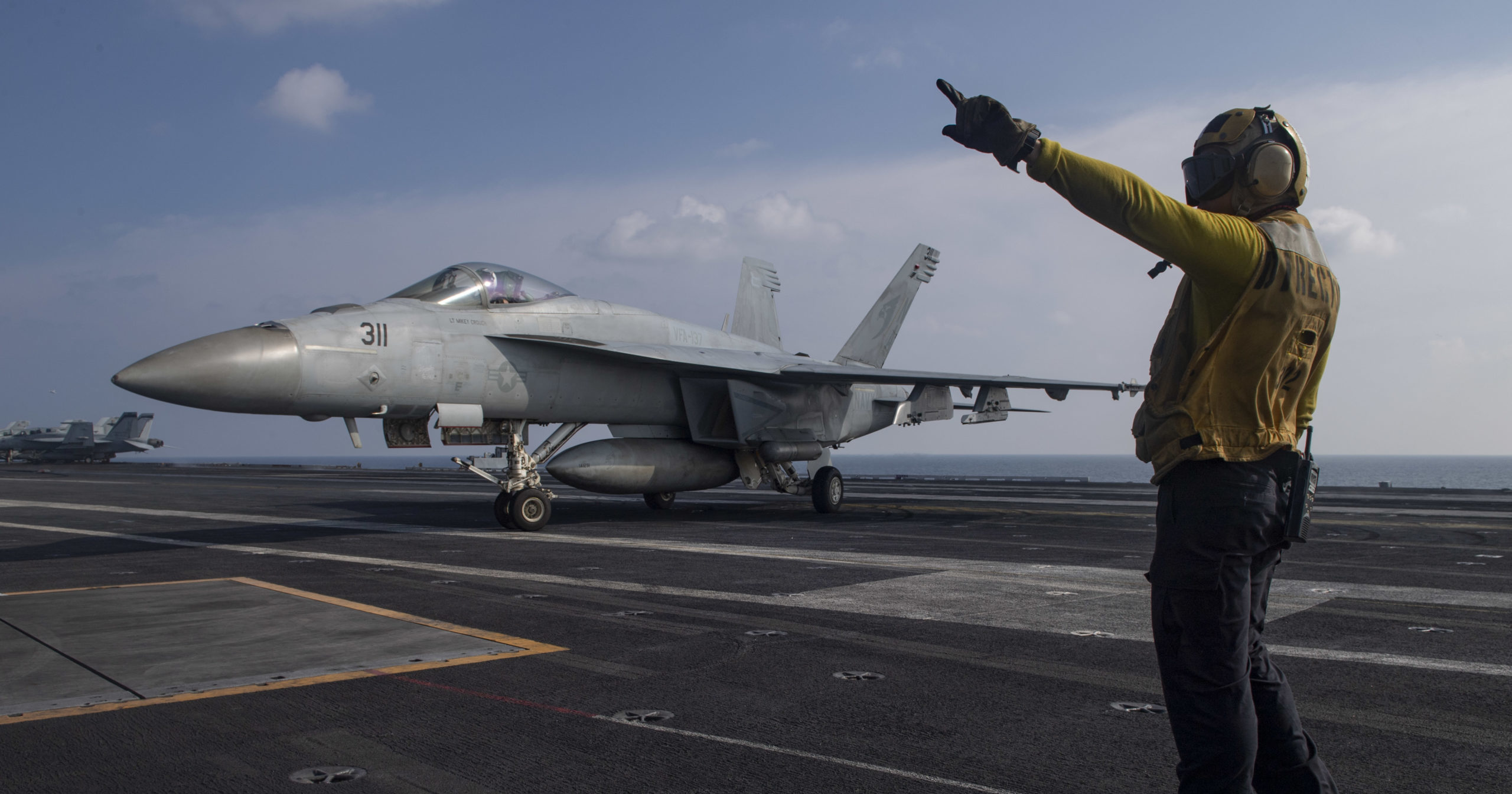 Aviation Boatswain's Mate 3rd Class Marnell Maglasang, from La Puente, California, directs an F/A-18E Super Hornet on the flight deck of the aircraft carrier USS Nimitz in the Arabian Sea on Nov. 27, 2020.