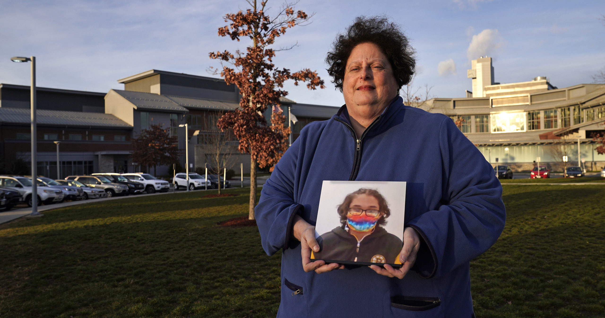 Laura Dilts, of Barre, Massachusetts, holds a photograph of her 16-year-old son outside the Worcester Recovery Center, where he is a resident patient receiving assistance for his mental health, on Nov. 23, 2020, in Worcester, Massachusetts.