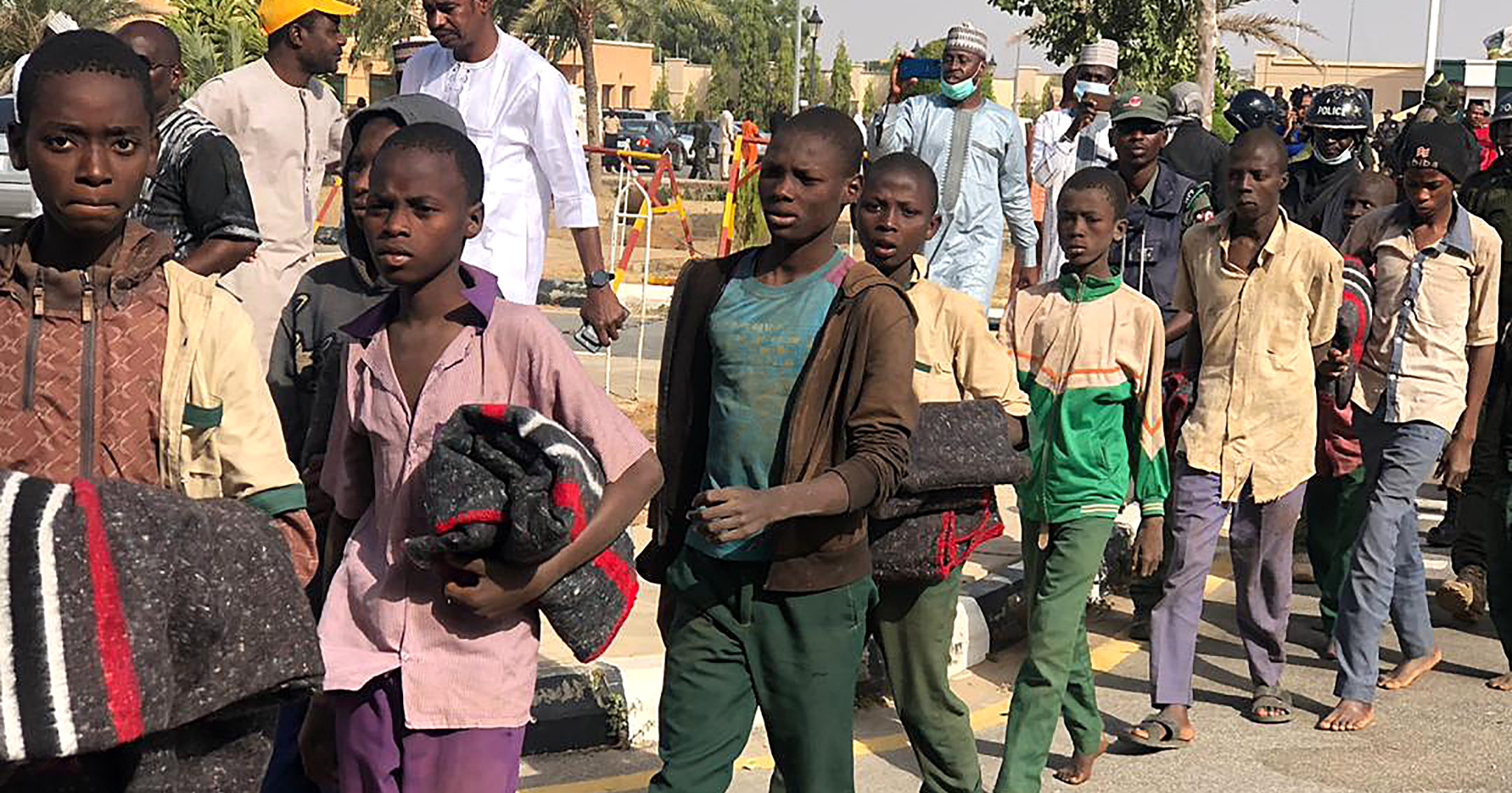 Schoolboys are escorted by the Nigerian military on Dec. 18, 2020, in Katsina state, Nigeria, following their release by their Boko Haram captors.