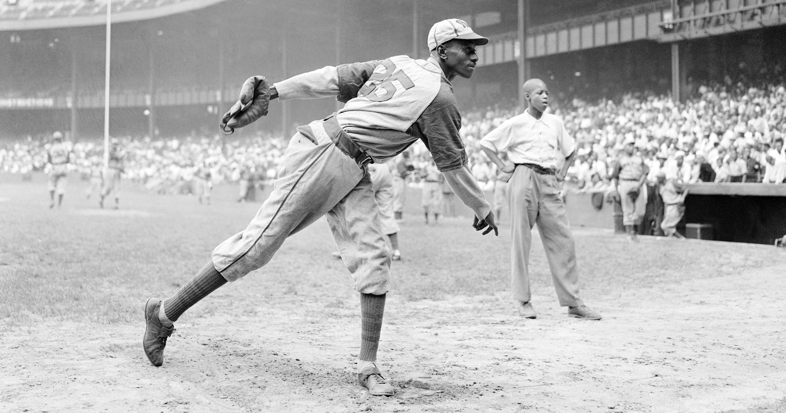 In this Aug. 2, 1942, file photo, Kansas City Monarchs pitcher Leroy Satchel Paige warms up at New York's Yankee Stadium before a Negro League game between the Monarchs and the New York Cuban Stars.