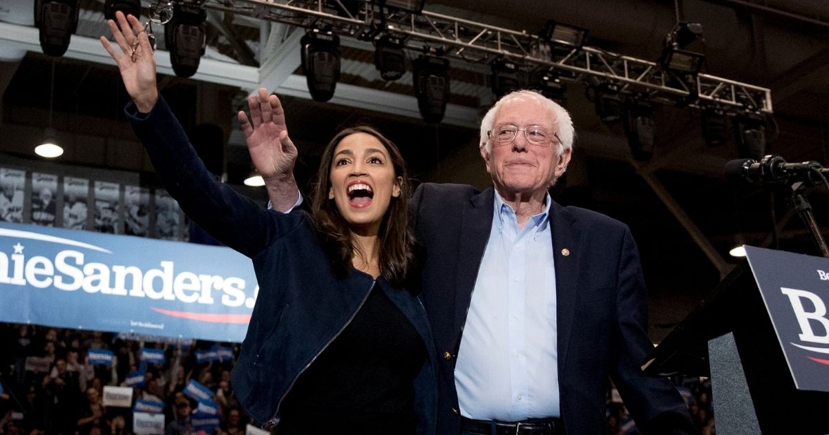 Sen. Bernie Sanders, right, accompanied by Democratic New York Rep. Alexandria Ocasio-Cortez, takes the stage at a campaign stop at the Whittemore Center Arena at the University of New Hampshire on Feb. 10, 2020, in Durham, New Hampshire.