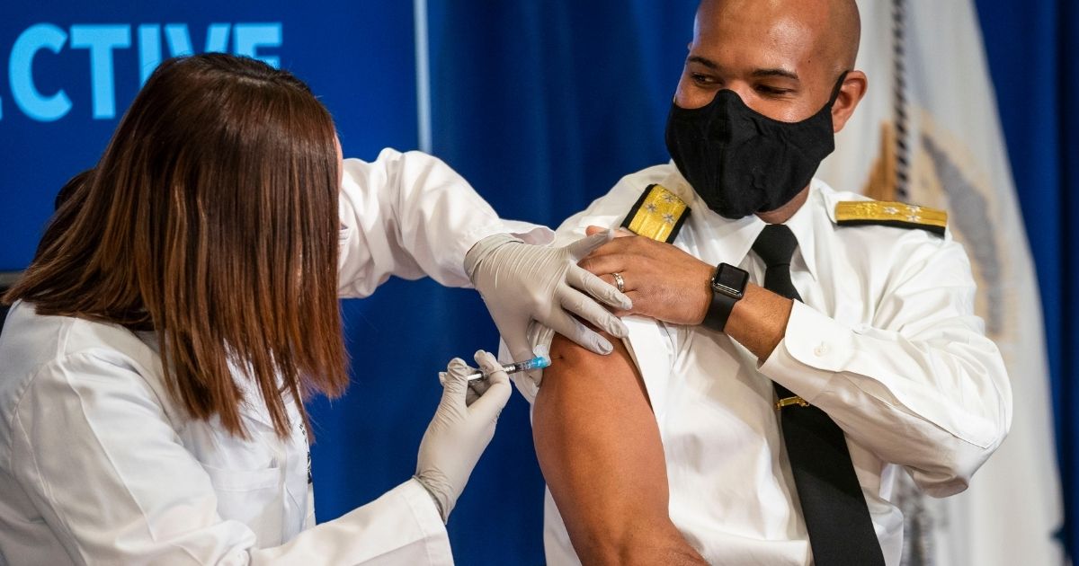 Surgeon General Jerome Adams receives a COVID-19 vaccine to promote the safety and efficacy of the vaccine at the White House on Friday in Washington, D.C.