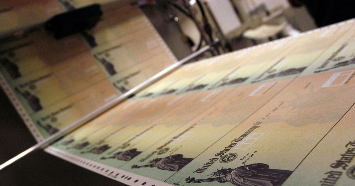 Blank checks are run through a printer at the U.S. Treasury printing facility Philadelphia in a 2005 file photo.