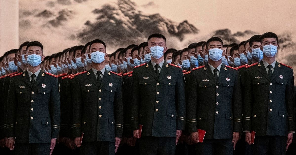 Chinese soldiers from the People's Liberation Army wear protective masks as they line up before a ceremony marking the 70th anniversary of China's entry into the Korean War on Oct. 23, 2020, at the Great Hall of the People in Beijing.