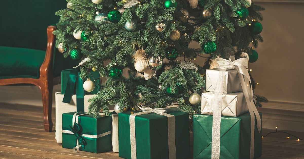 A Christmas tree is pictured with presents in the stock image above.