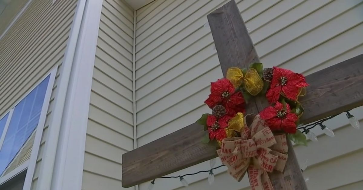 A family that stood by their faith regardless of threats that it would cost them has battled a local homeowners association to keep a cross as part of its Christmas decorations.