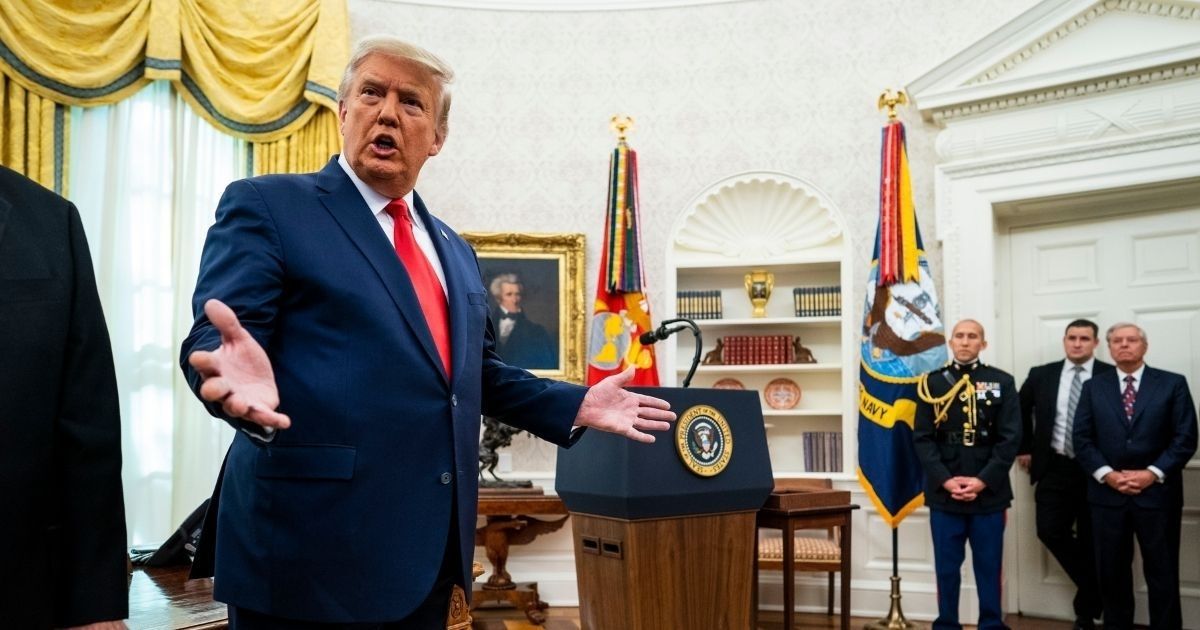 President Donald Trump speaks about the election after presenting the Medal of Freedom to former college football coach Lou Holtz in the Oval Office of the White House on Thursday in Washington, D.C.