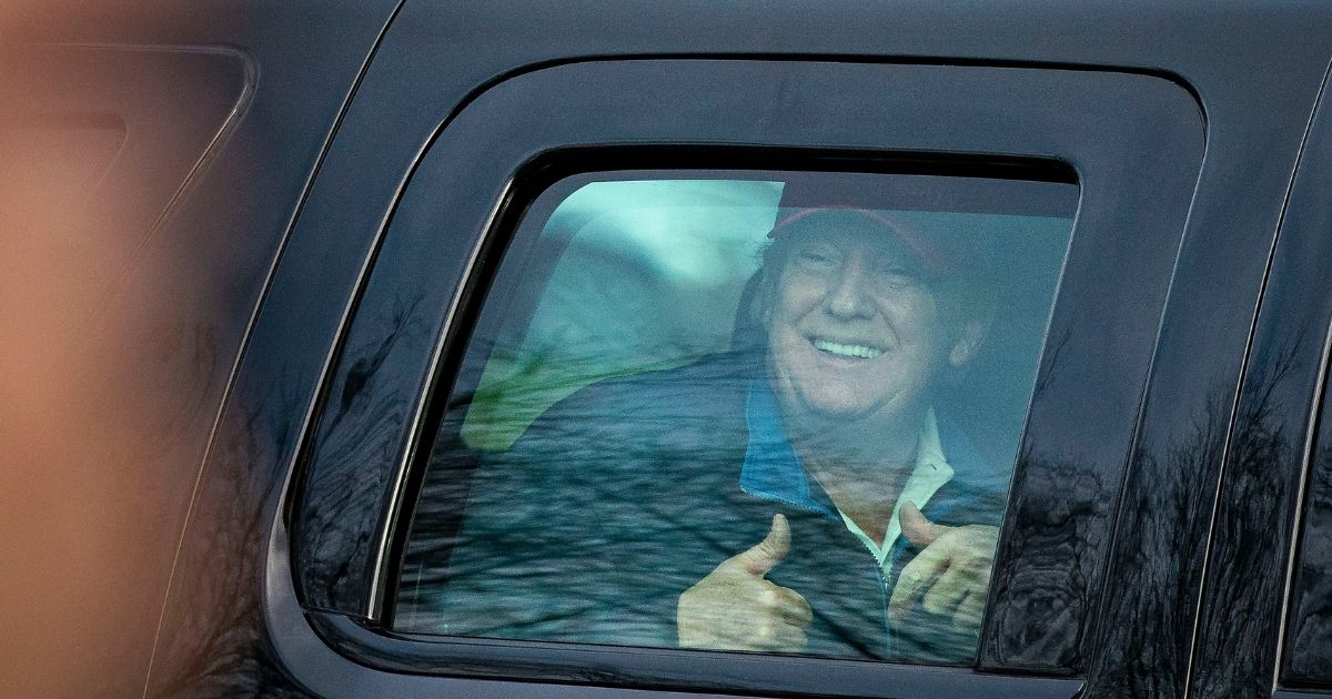 President Donald Trump gives a thumbs up towards supporters as he departs Trump National Golf Club on Dec. 13, 2020, in Sterling, Virginia.