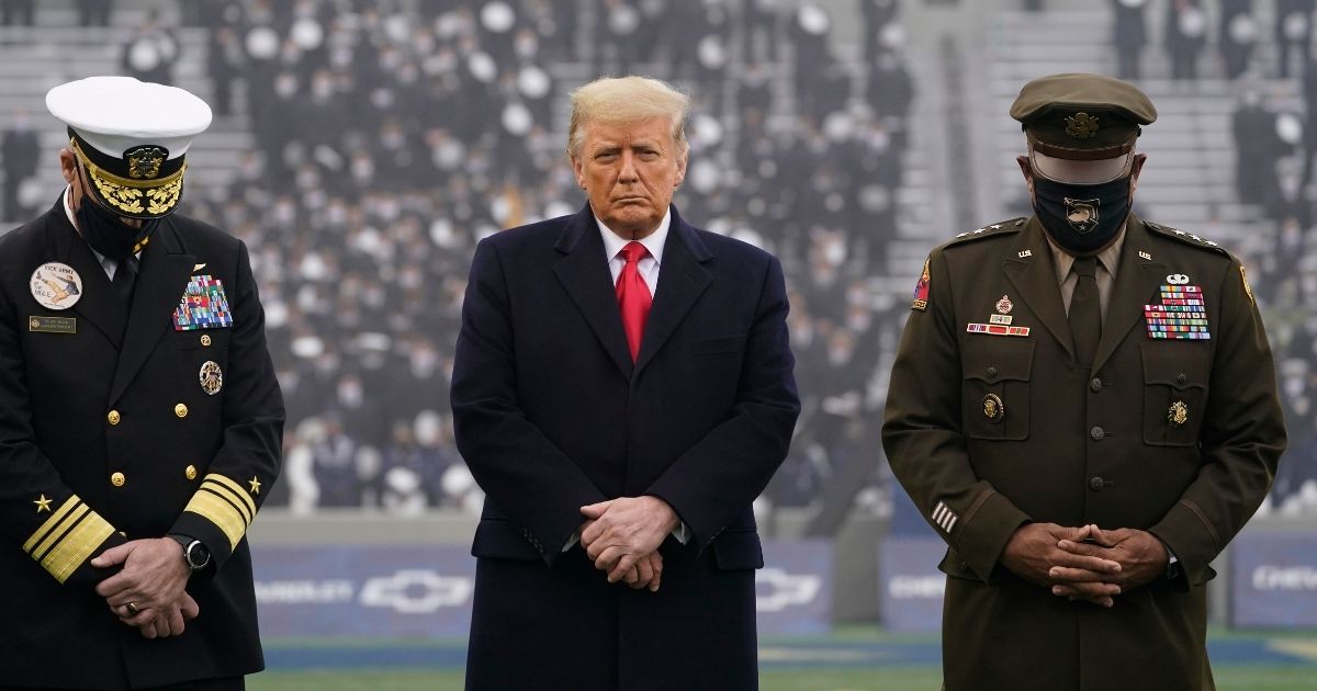 President Donald Trump stands on the field before the 121st Army-Navy Football Game in Michie Stadium at the United States Military Academy on Saturday in West Point, New York.