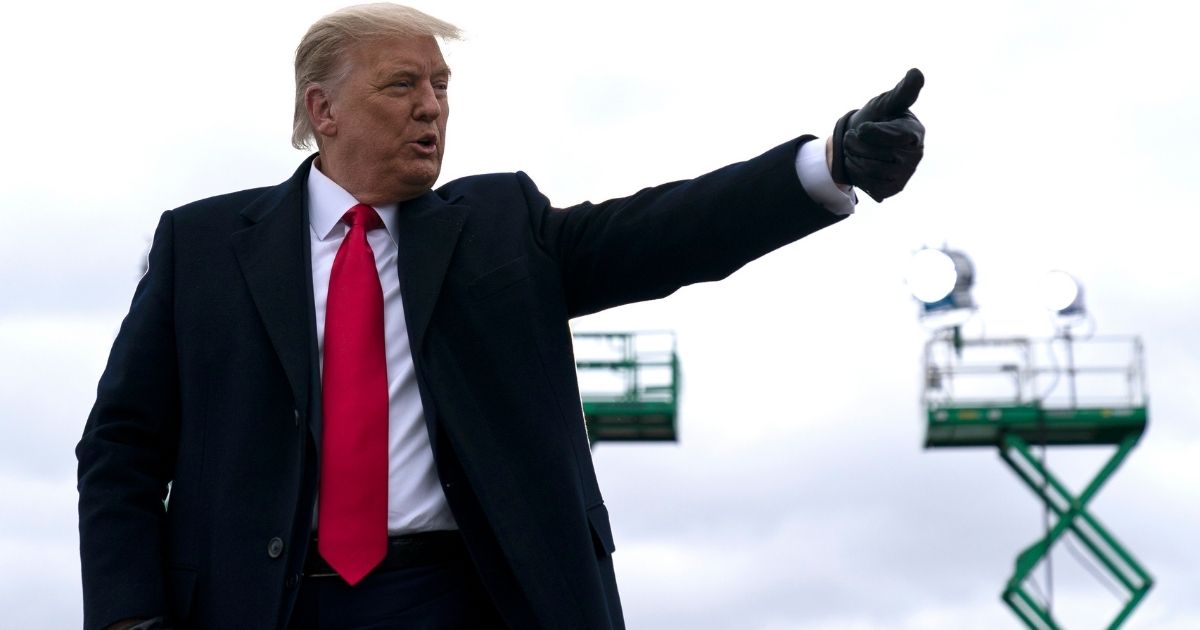 President Donald Trump gives a thumbs up to supporters after speaking at a campaign rally at Oakland County International Airport on Oct. 30, 2020, at Waterford Township, Michigan.