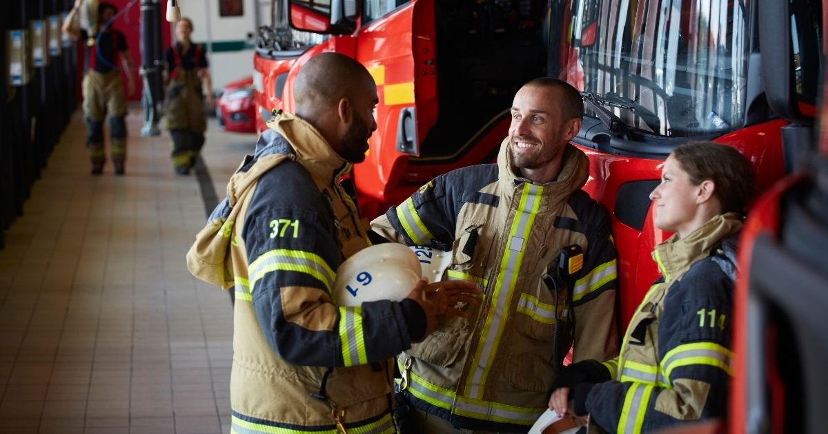 More than half of New York City's firefighters who participated in a union survey have said they have no plans to be vaccinated against COVID-19. The above stock image shows firefighters talking in uniform.