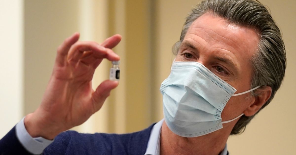 Democratic Gov. Gavin Newsom of California holds up a vial of the Pfizer-BioNTech COVID-19 vaccine at Kaiser Permanente Los Angeles Medical Center last week.