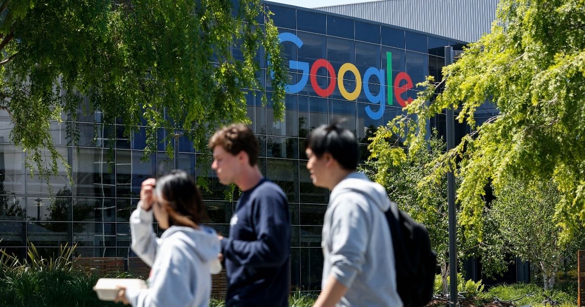 People walk in Google's main campus in Mountain View, California on May 1, 2019.