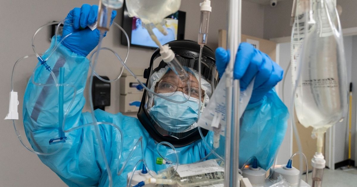 A medical staff member checks the IV drip for a patient in the COVID-19 intensive care unit at the United Memorial Medical Center on Thursday in Houston.
